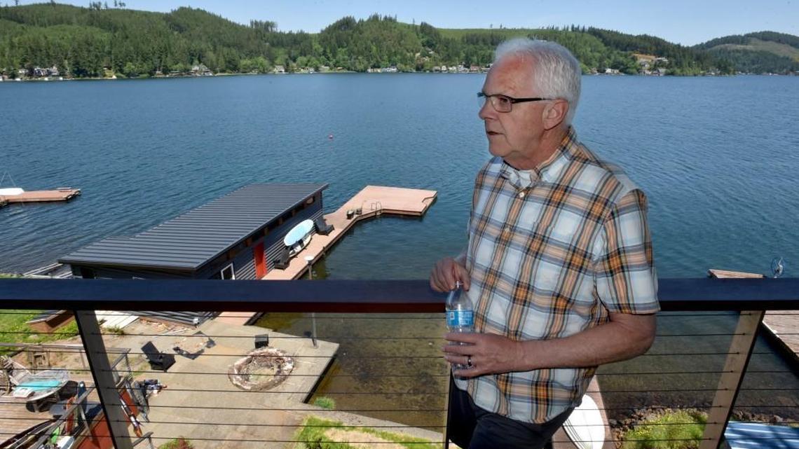 Standing on his deck overlooking Summit Lake on an atypically quiet Memorial Day Monday, resident Vaughn Hodgins talks about the effects on residents from the lake’s closure due to a toxic algae outbreak. The alert has forced homeowners to not drink lake water,and is a primary reason for the bottled water in his hand.