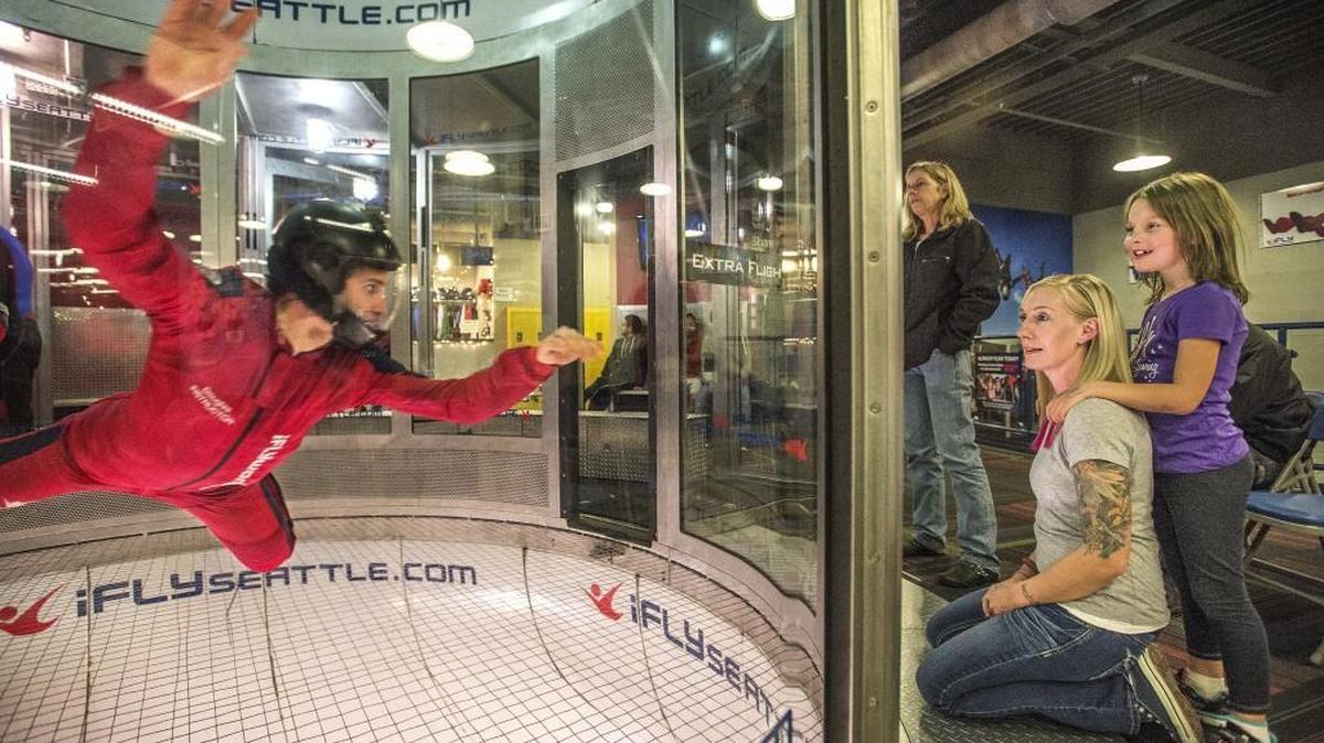 Stephanie Groepper, of Puyallup, founder of the Washington Warrior Widows, watches her daughter Clarissa learn to skydive during a play date at iFly in Tukwila. The mother-daughter duo are both taking lessons and hope one day to skydive together.