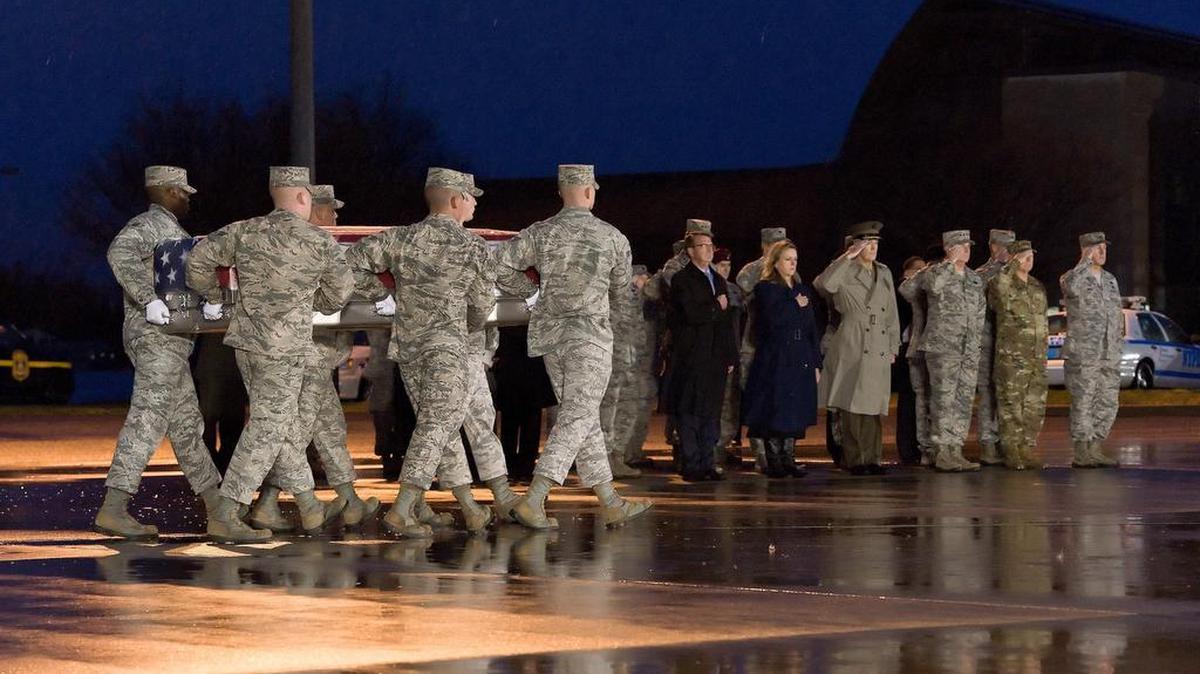 A U.S. Air Force carry team transfers the remains of Staff Sgt. Chester J. McBride, of Statesboro, Georgia, during a ceremony Dec. 23 at New Castle Air National Guard Base, New Castle, Delaware. He was one of six airmen killed in a suicide attack on Dec. 21 at Bagram Airfield.
