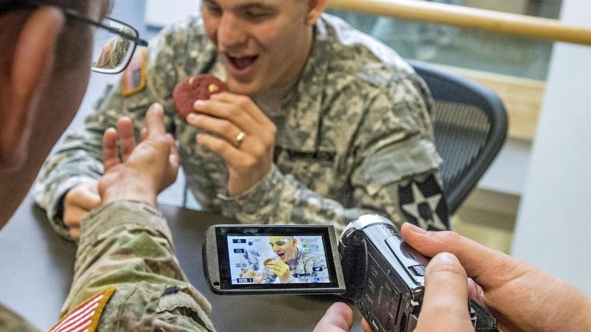 A cookie is taken from Spc. Charles Stevenson on Monday in the making of a short video for a program teaching veterans how to make movies at Joint Base Lewis-McChord. The program by I Was There Films is being offered this week as therapy for soldiers.