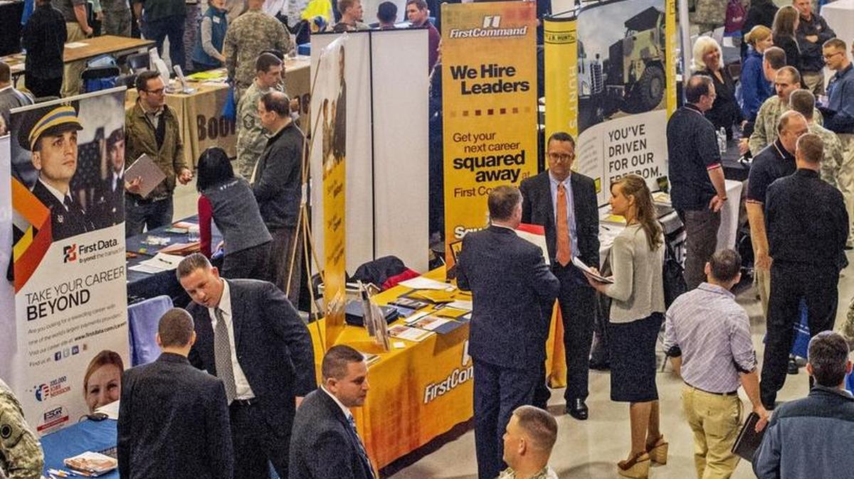 
Maj. Kevin James (right, foreground) shakes hands with Jason Goroff of First Data at the 2014 Washington State Military Transition Summit. The 2015 summit will kick of Tuesday, Sept. 22, peaking with another career fair at Joint Base Lewis-McChord on Thursday, Sept. 24. 
