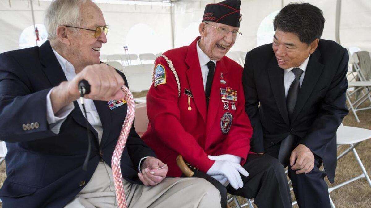 
Consul General Moon Duk-ho, right, from the Republic of Korea Consulate in Seattle shares a laugh Friday with World War II veterans Jack Colman, center, 88, of Seattle, and Richard Kirk, 92, of Tacoma at the World War II Memorial in Olympia. Moon thanked the veterans for their service and acknowledged the impact the end of World War II had on Korea's restoration of independence.
