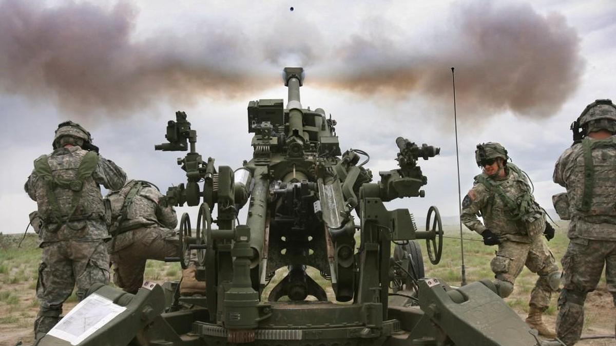 Staff file: Spc. Robert Howell (facing) of Port Orchard, Wash., and fellow soldiers with the 1st Battalion, 37th Field Artillery Regiment from Joint Base Lewis-McChord, fire the M777 Howitzer, a 155mm cannon with an range of 15- to 25 miles, during combat training at the Yakima Training Center on Monday, May 23, 2011. The firing process resembles a NASCAR pit stop, with eight company members reloading and firing a round every 20 seconds. Locally, training with Howitzers will continue through midnight Thursday.
