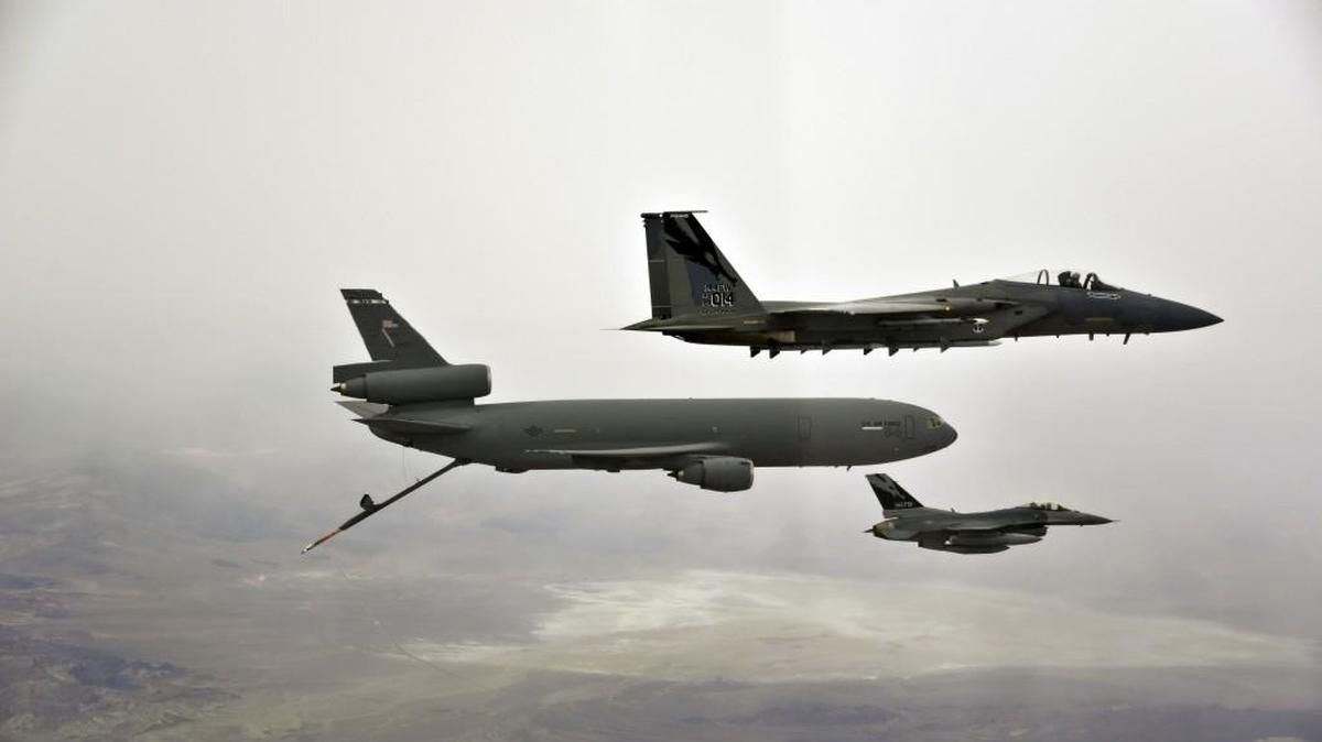 
A U.S. Air Force F-16C Fighting Falcon, bottom, and an F-15 Eagle, top, fly in November 2013 alongside a KC-10 Extender from Travis Air Force Base, California. Three F-16 jets are among the various planes that will visit Joint Base Lewis-McChord over the next year to help the Air Force test a new refueling tanker Boeing is developing in the Puget Sound region.
