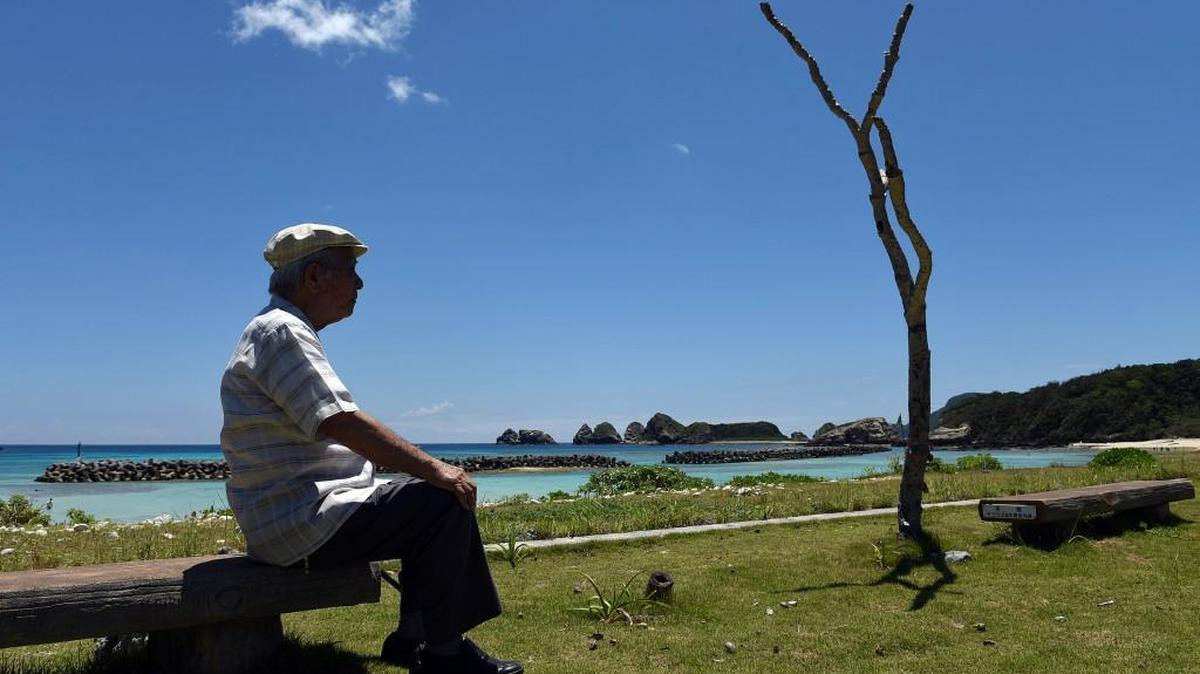 Takeichi Kakinohana, 85, sits in August on a beach on Aka Island, Japan, where, when he was a teenager, the U.S. military landed prior to invading Okinawa. Kakinohana was conscripted by the Japanese army to help defend the island, and his memories of the time have helped shape his pacifist beliefs.