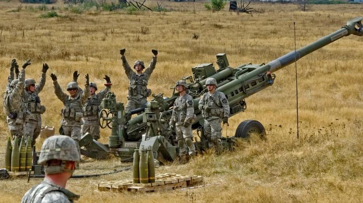 A howitzer crew cheers for a group of visitors at Joint Base Lewis-McChord.