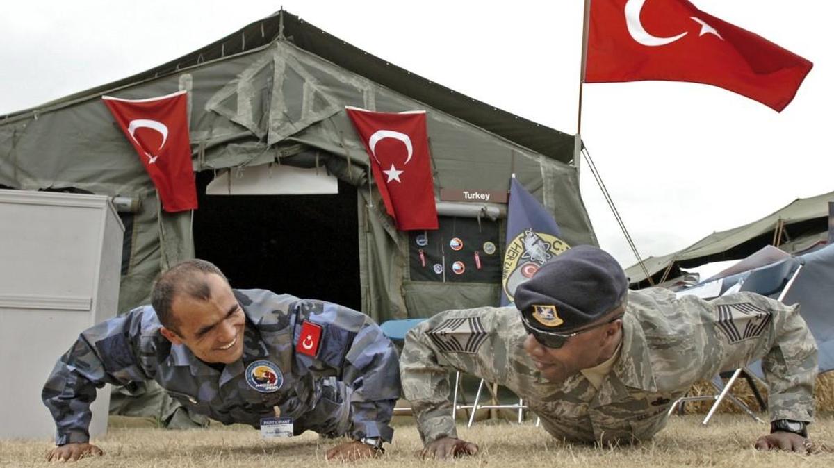 Air Mobility rodeos at Joint Base Lewis-McChord often provided opportunities for airmen from around the world to bond. In this 2009 photo, Airman Erdogan Kaya of the Turkish Air Force (left) has a friendly push-up competition with Master Sgt. Larry Similton of JBLM.