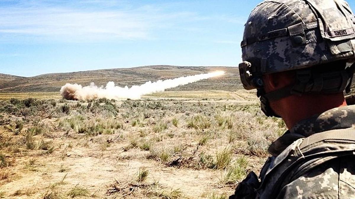 A soldier from Joint Base Lewis-McChord’s 17th Field Artillery Brigade watches a High Mibility Artillery Rocket System launch a training round at the Yakima Training Center in May 2014.