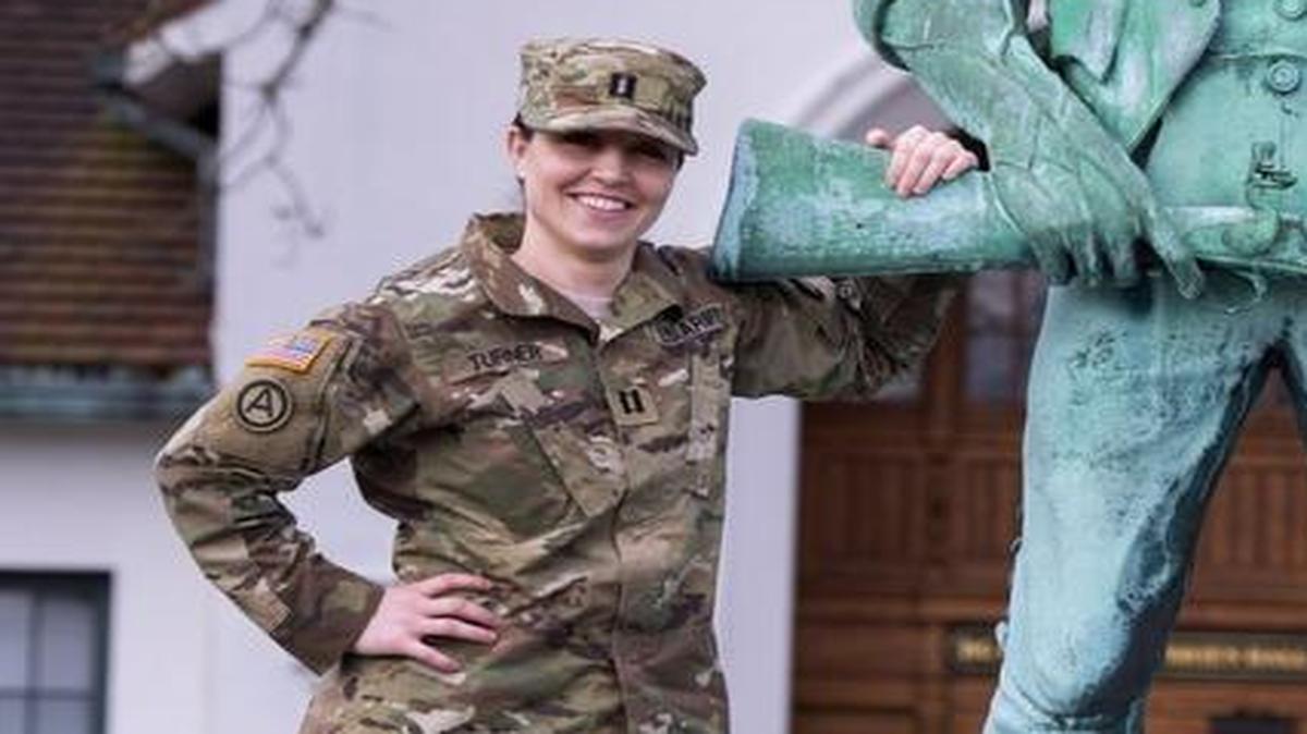 Capt. Kerri Turner poses with Fred, the Minuteman statue, at Camp Murray on Wednesday, Feb. 24. Turner won the Ms. Veteran America title last year with a performance she wrote that paid homage to female veterans dating back to the American Revolution.