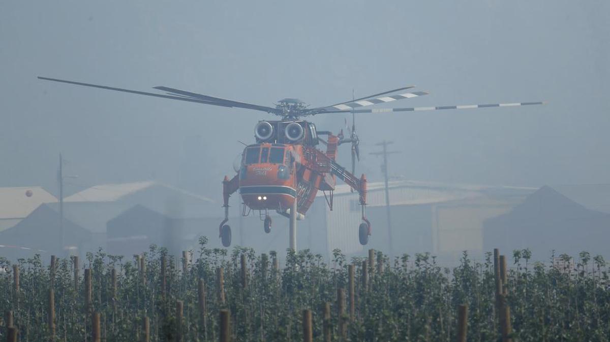 
A tanker helicopter used for fighting wildfires takes off in smokey conditions from a helicopter base Tuesday just outside of Chelan.
