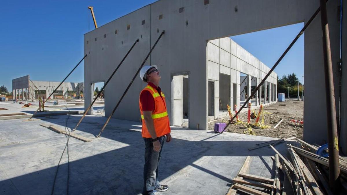 Dustin Rotter, principal owner of Toyota of Olympia, inspects on Tuesday his new 93,500-square-foot dealership that’s being built on 28 acres in Tumwater.