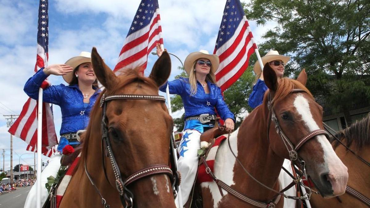 Nicole Wiseman (from left), Petee Hoyt and Lisa Kibler lead the American Made Rodeo Drill Team during the 2013 Tumwater Fourth of July parade.