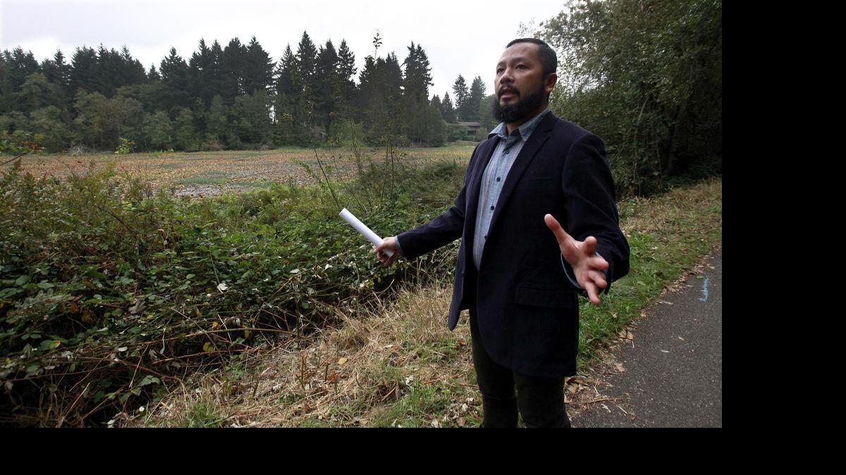 
2014 file photo: During an October tour, project manager Jay Sueno points out the wetland attributes along the proposed 20-acre site for Bayan Trails, a low impact development for senior housing on the outskirts of Olympia across from North Thurston High School. It has been a dream of the Sueno family to build this type of housing surrounded by retained natural woodland.
