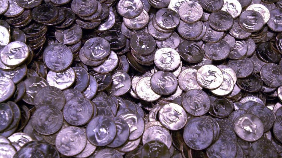 A binful of newly minted Kennedy half-dollar coins sit in the Denver Mint in 2000.