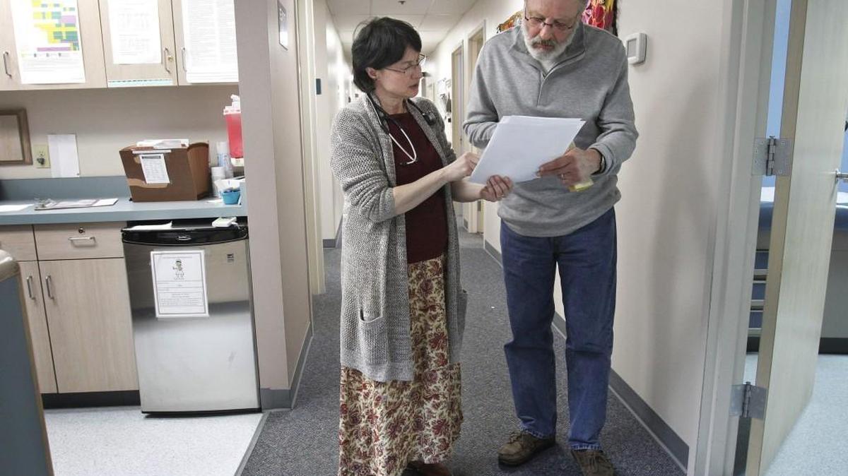 Dr. Lucinda Grande (left) talks with patient Rick Gleason at the Pioneer Family Practice clinic in Lacey on April 21, 2015. Gleason said that tiny doses of ketamine have successfully relieved his previously untreatable pain.