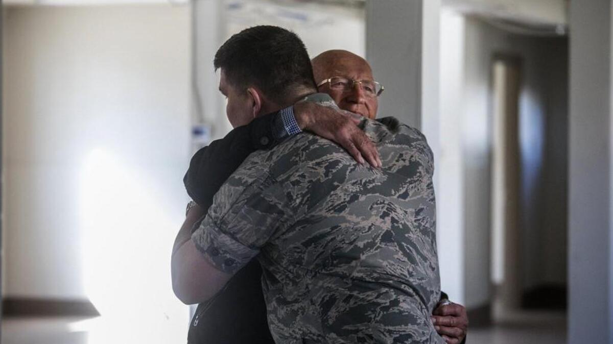 An emotional farewell after Günter Gräwe, a German POW held at Joint Base Lewis-McChord during World War II, finishes touring a former barracks with Deputy Joint Base Commander Col. William Percival.