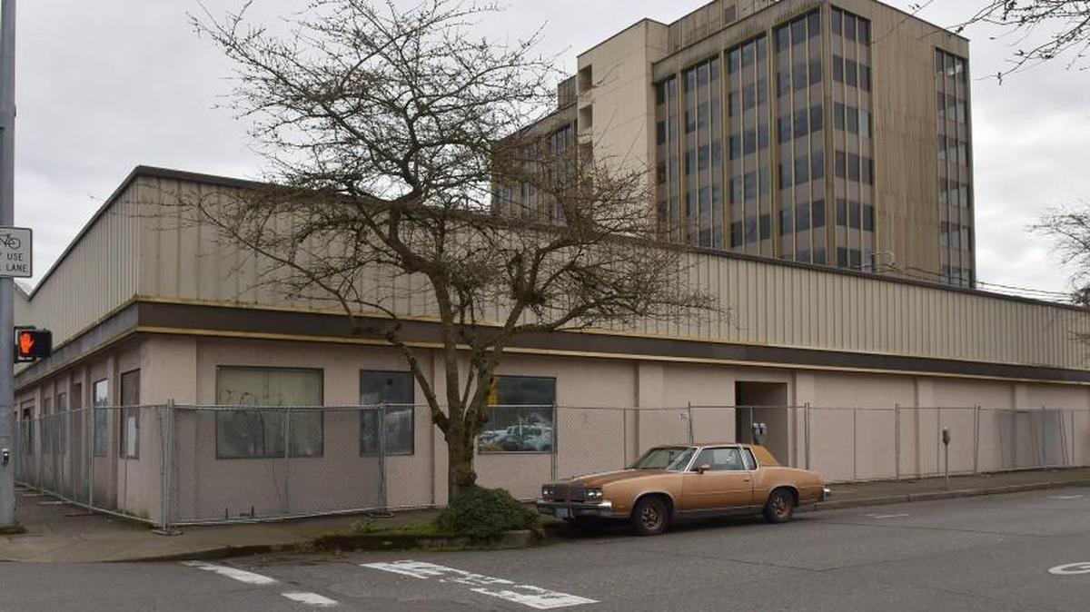 Fencing borders the long-vacant building at 411 Fourth Avenue West as the City of Olympia prepares for its demolition. The work begins Tuesday and concludes March 23.
