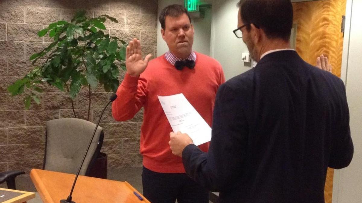 Andy Ryder, facing City Attorney Dave Schneider, was sworn in as Lacey’s mayor Thursday night. This is his third, two-year term as mayor.