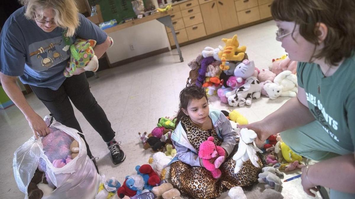 Girl Scouts Troop 45297 leader Debbie Kerrick, from left, gets help sorting plush toys from scouts Desi Brathovb, 7, and Althea Kerrick, 9, as they prepare for Barb O’Neill’s Family and Friends Easter basket giveaway at First United Methodist Church in Olympia on Saturday.