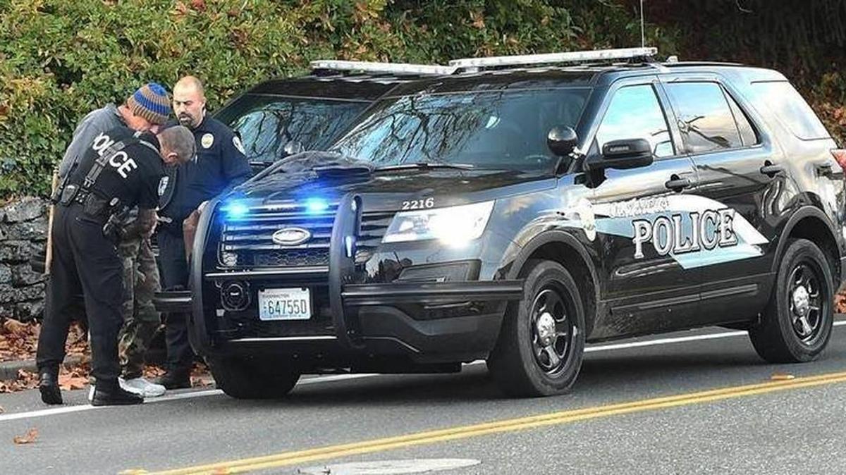Olympia police take a suspected bank robber into custody Monday afternoon.
