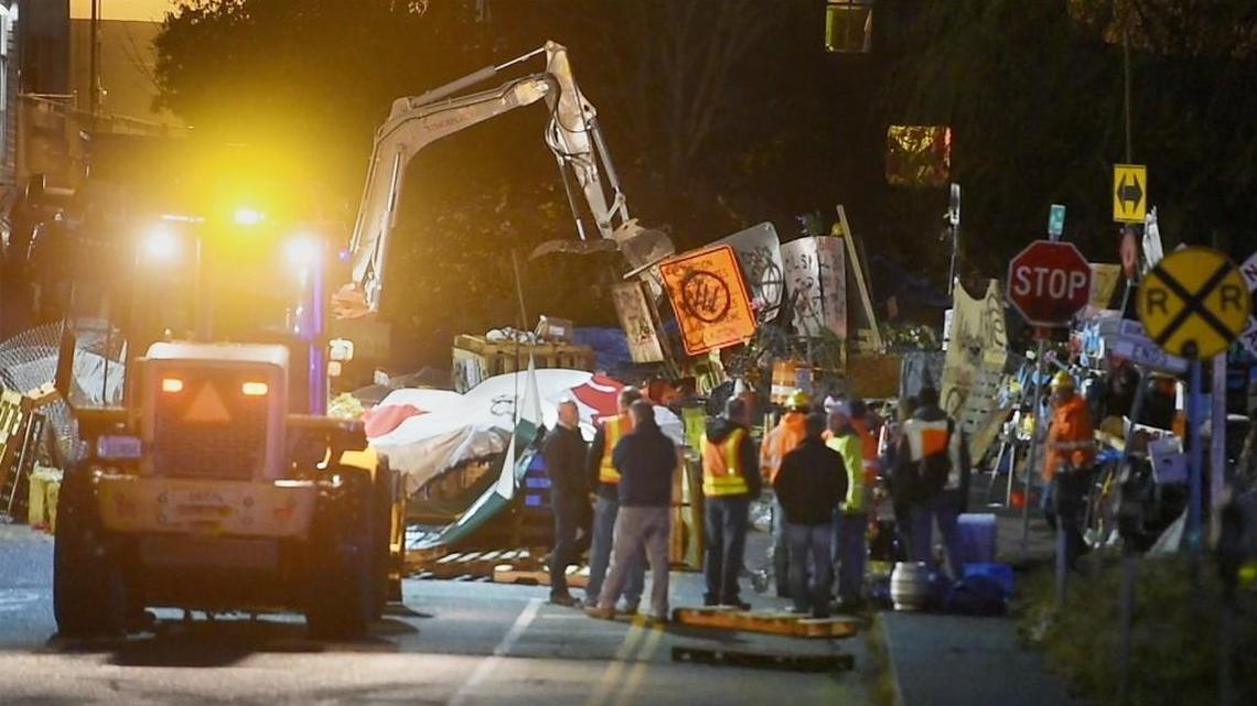 Crews work to clear an encampment blocking railroad tracks in downtown Olympia the morning of Nov. 29, 2017.