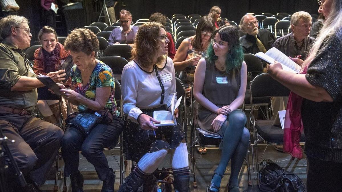 
Author Jim Tweedie (from left), illustrator Kathryn Wanless, Jim's wife Jeanine Tweedie, author Megan Macvie and author Caelyn Williams and author Kim K. O'Hara (far right) join fellow writers as they exchange autographs before the Timberland Writes Together authors panel at the Washington Center Black Box Theater in downtown Olympia on Thursday, Oct. 8, 2015.
