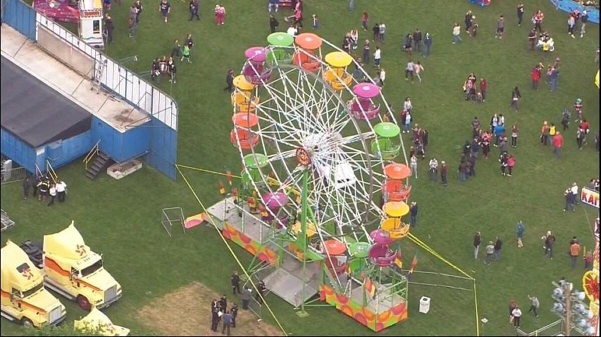 Police tape surrounds a Ferris wheel at the Jefferson County Rhododendron Festival in Port Townsend on Thursday evening after an accident sent three people falling 30 feet from the carnival ride. The three people were each taken by helicopter to Harborview Medical Center in Seattle for treatment of their injuries.