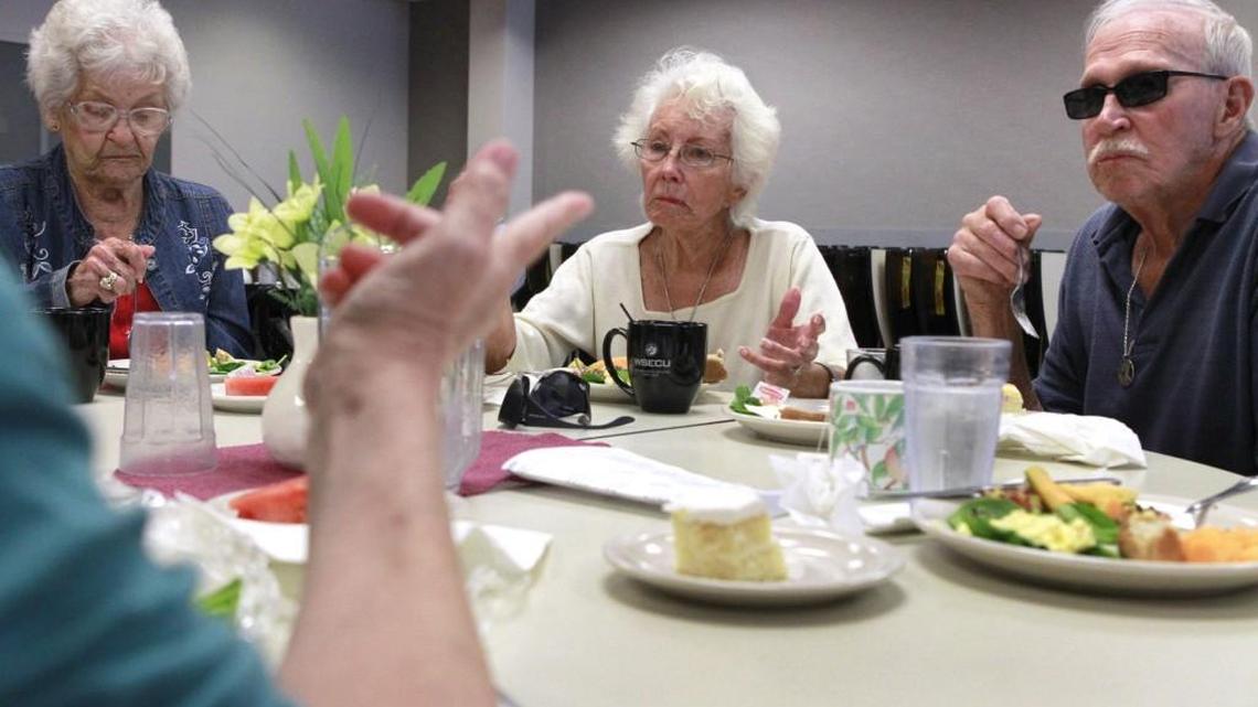 Delpine Gray (from left), Carolyn Garvin and Spook Garvin talk with friends during lunch at the Olympia Senior Center on Thursday, Aug. 7, 2014. The center also offers a variety of classes and there’s a meet the teacher event Wednesday.