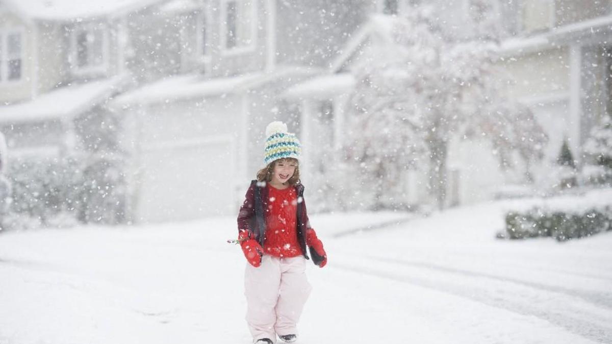 Four-year-old Clara Johnson plays in the snowfall in Tumwater on Friday.
