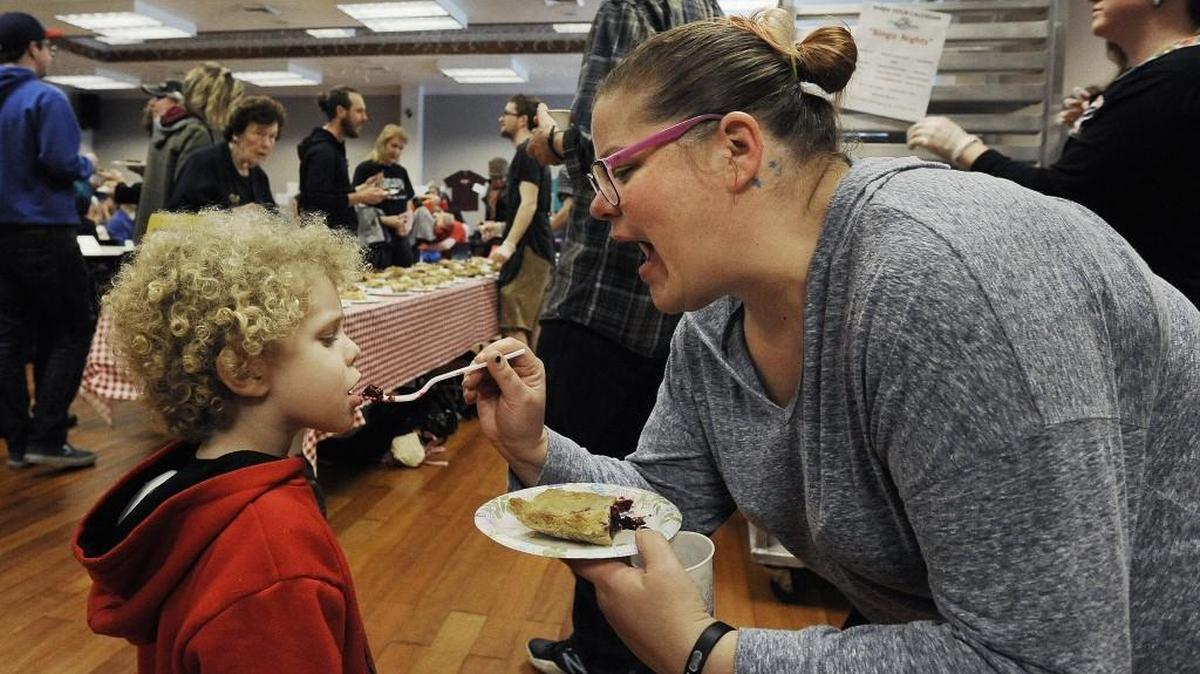 Amanda Borges gives her 4-year-old son Skyler a berry good sample of one of the 175 fresh pies available Saturday during the Olympia Bakers Guild’s 8th Annual Pie Fest at The Olympia Center in downtown Olympia.