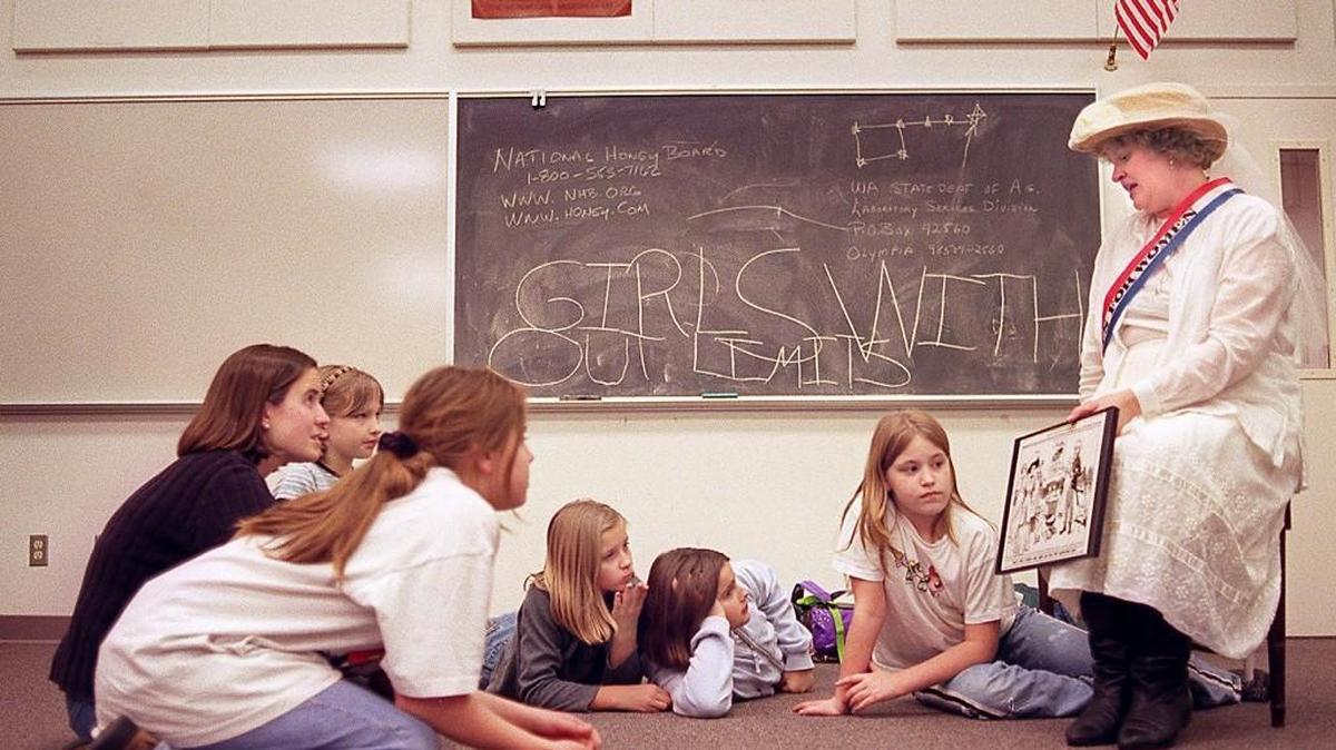 The League of Women Voters — of which Sue Lean, right, was a representative when she met dressed as a suffragette as she talked with a Girls Without Limits gathering in March 2000 at Roosevelt Elementary School in Tacoma — will sponsor a Education Fund Benefit Luncheon on Saturday in Olympia.