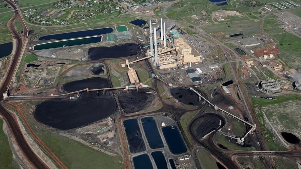 Colstrip Steam Electric Station power plants 1, 2, 3 and 4 are seen in 2013 near Colstrip, Montana. The plant, which serves utility customers in the Pacific Northwest, has agreed to shut down two of its four units by 2022 under a settlement announced Tuesday with environmentalists who sued over alleged air pollution violations.