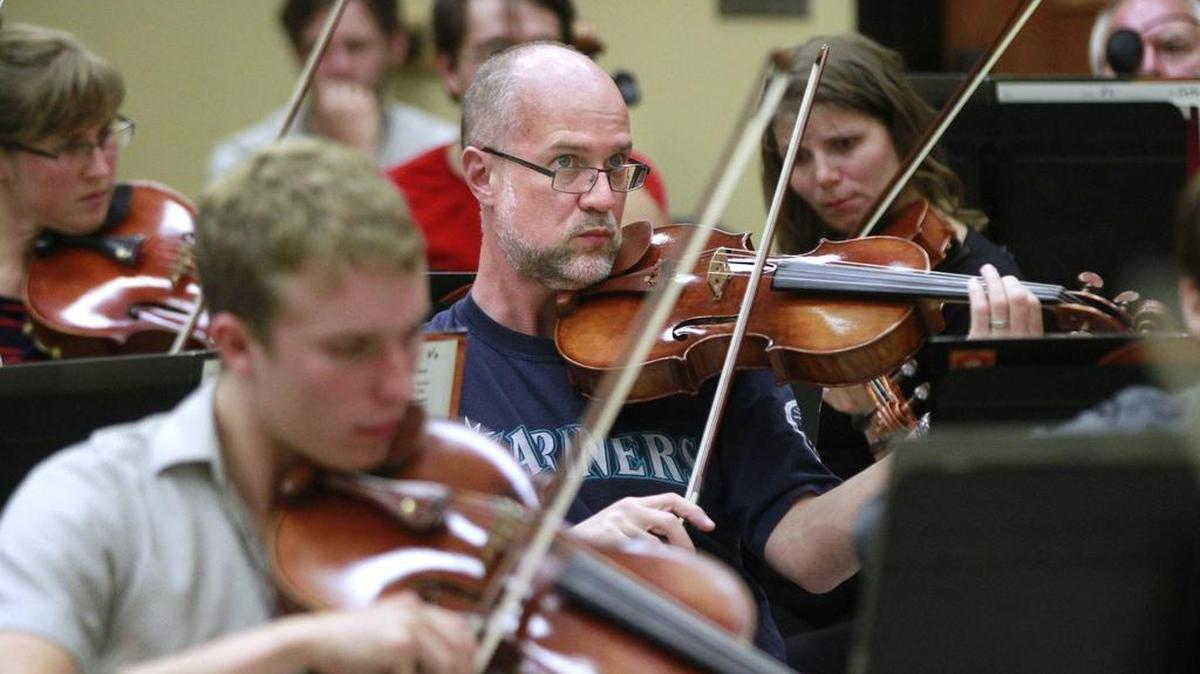 Viola player Alan Fuller of Tumwater performs during orchestra rehearsal at South Puget Sound Community College in Tumwater on Thursday, Sept. 25, 2014.