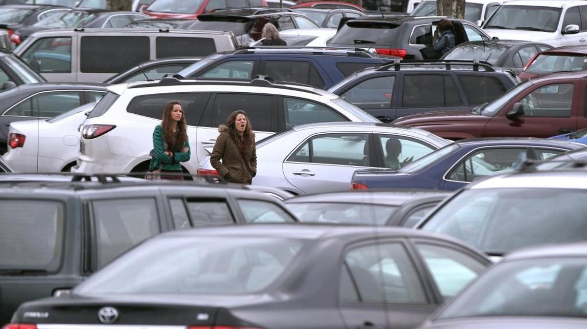 Shoppers walk through a packed parking lot at Capital Mall in 2013.
