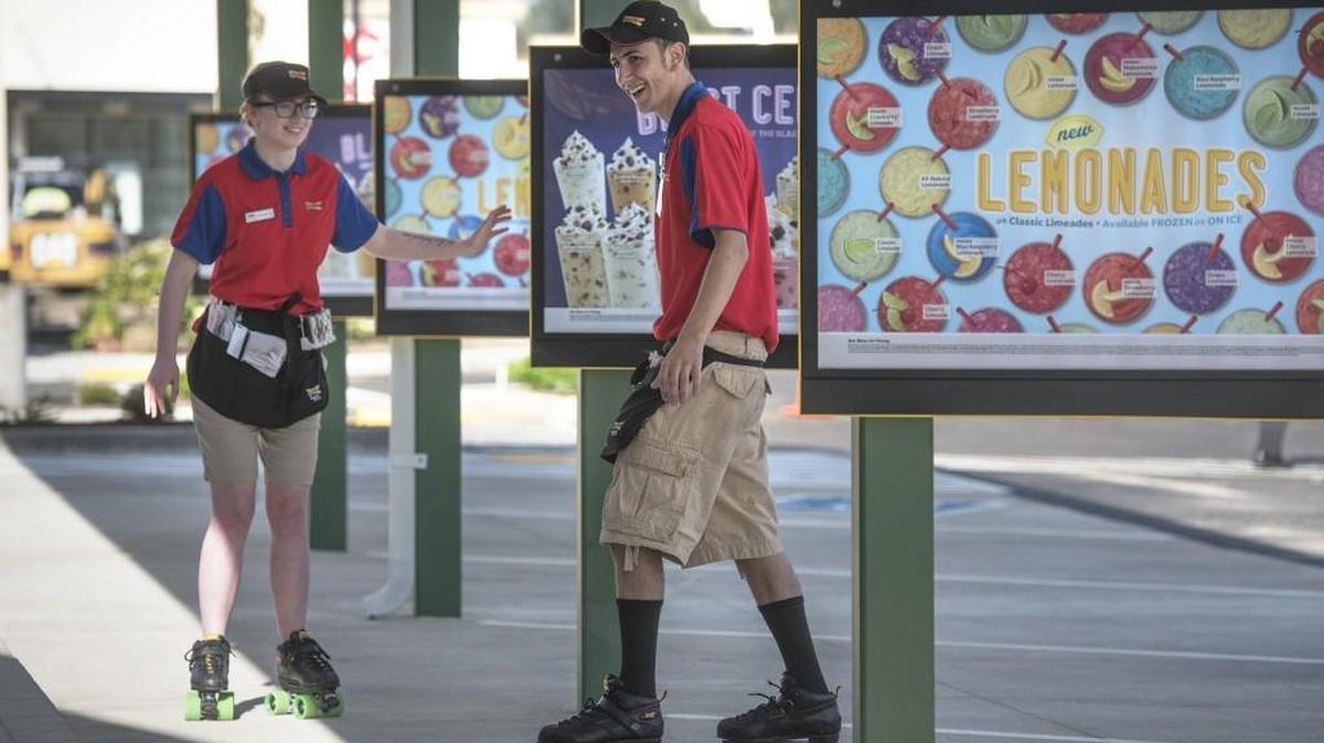Brayden Vaughn (right) warms up on skates with a co-worker as they prepare for the opening of the new Sonic restaurant in Lacey on Tuesday, April 19, 2016.