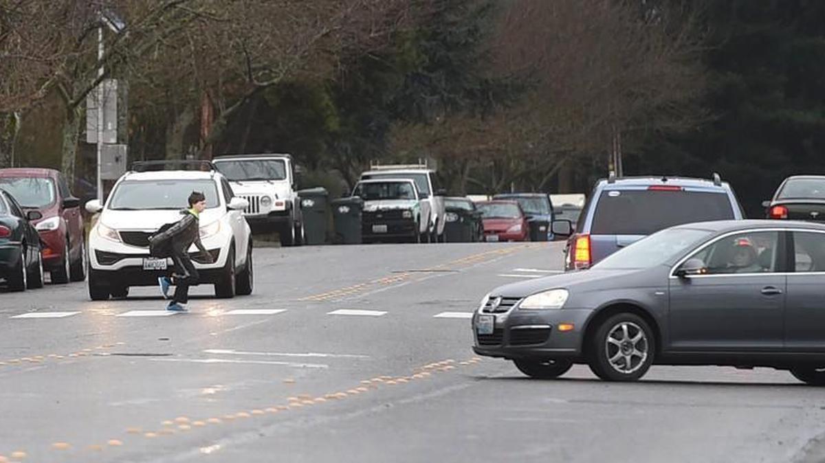 A student dashes across the crosswalk located along Sixth Ave. NE between Chinook Middle School and North Thurston High School Feb 4. after the Lacey Police Dept. added a lighted speed indicator for motorists. The upgrade comes after a teen was struck in that crosswalk Jan. 29 while walking to the high school.