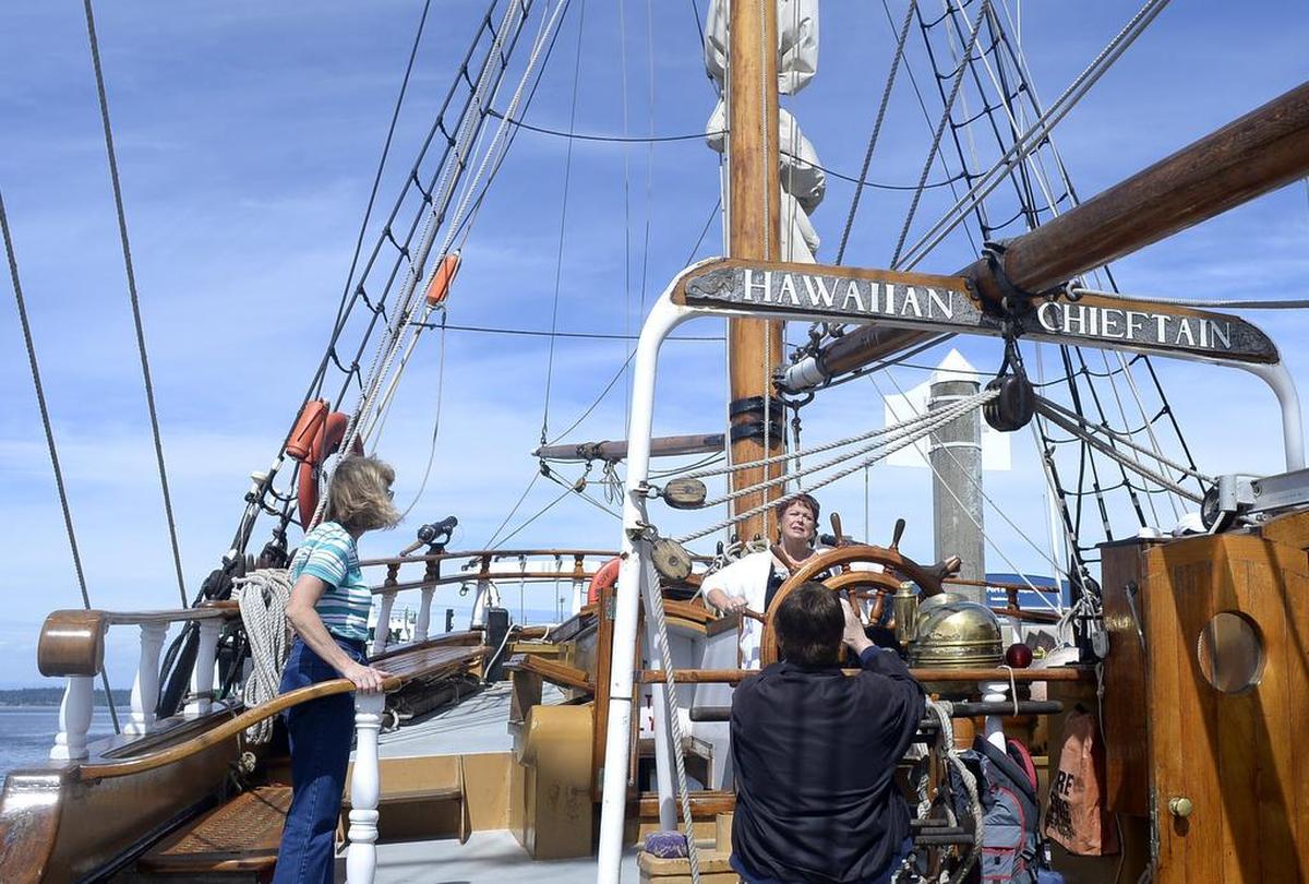 Ordie Johnson captures a photo of his sister Sandy Ferasch at the helm of the tall ship Hawaiian Chieftain during one of the ships visits to Olympia.
