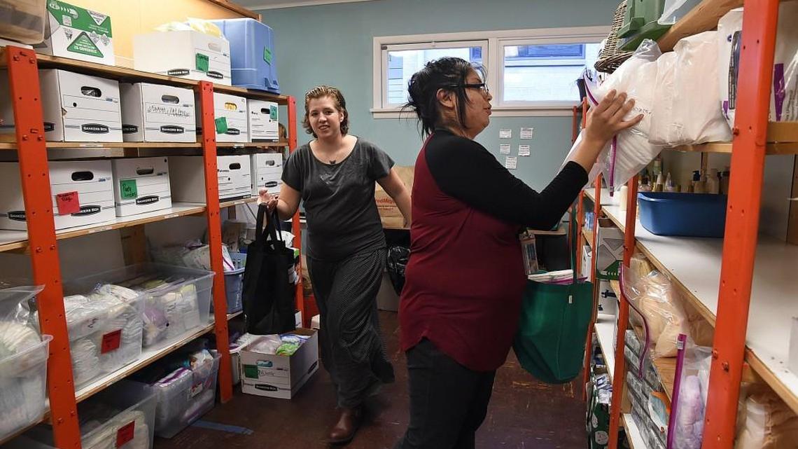 Heather Freeman, left, and Nancy Hadley fill several clients’ orders during the weekly distribution day Wednesday at the YWCA’s Other Bank in downtown Olympia. The program provides essential hygiene and cleaning items that can’t be purchased with food stamps and currently serves around 125 families a week.