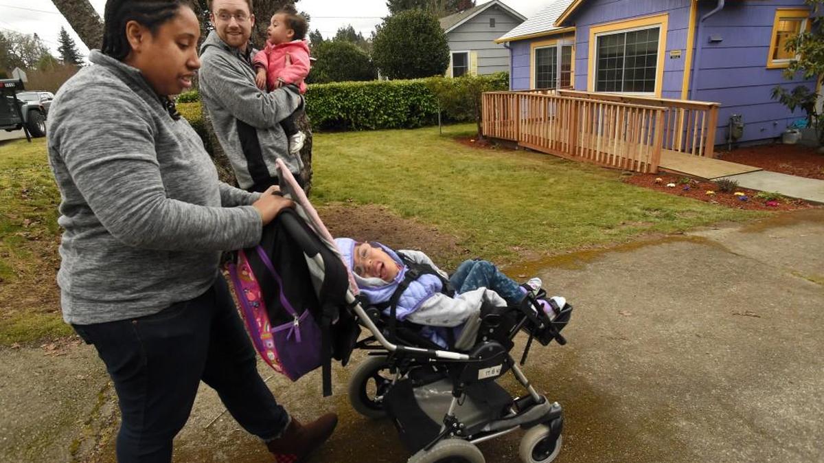 Six-year-old Mia Swigert and her family — parents Adam Swigert and Eva Carwell and little sister Zoe — have an easier time getting into their Olympia house Monday after school because of the volunteer work by the Mr. Do Right Construction, which this weekend finished their ramp.