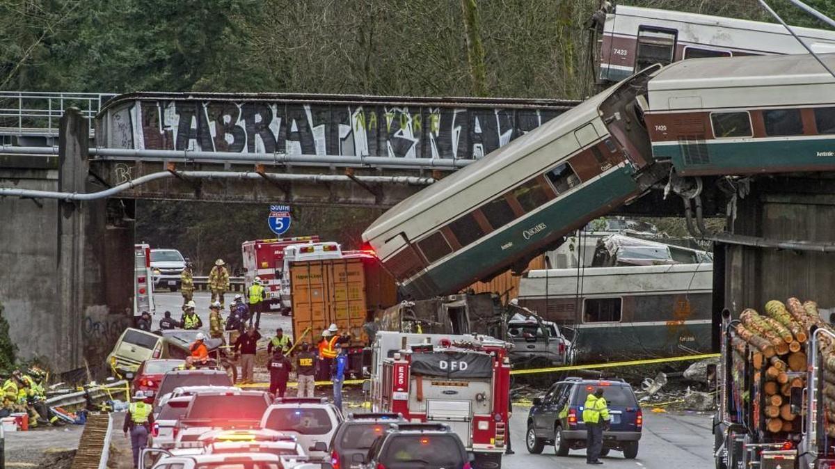 Several cars from an Amtrak passenger train dangle from an overpass onto the lanes of Southbound I-5 near DuPont on Dec. 18, 2017.