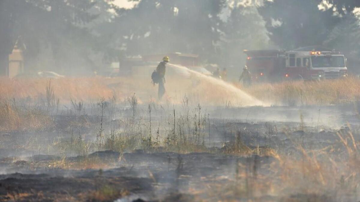 Crews respond to a large brush fire in Rochester in August. Fire officials say weather conditions in the county have created substantial fire danger.