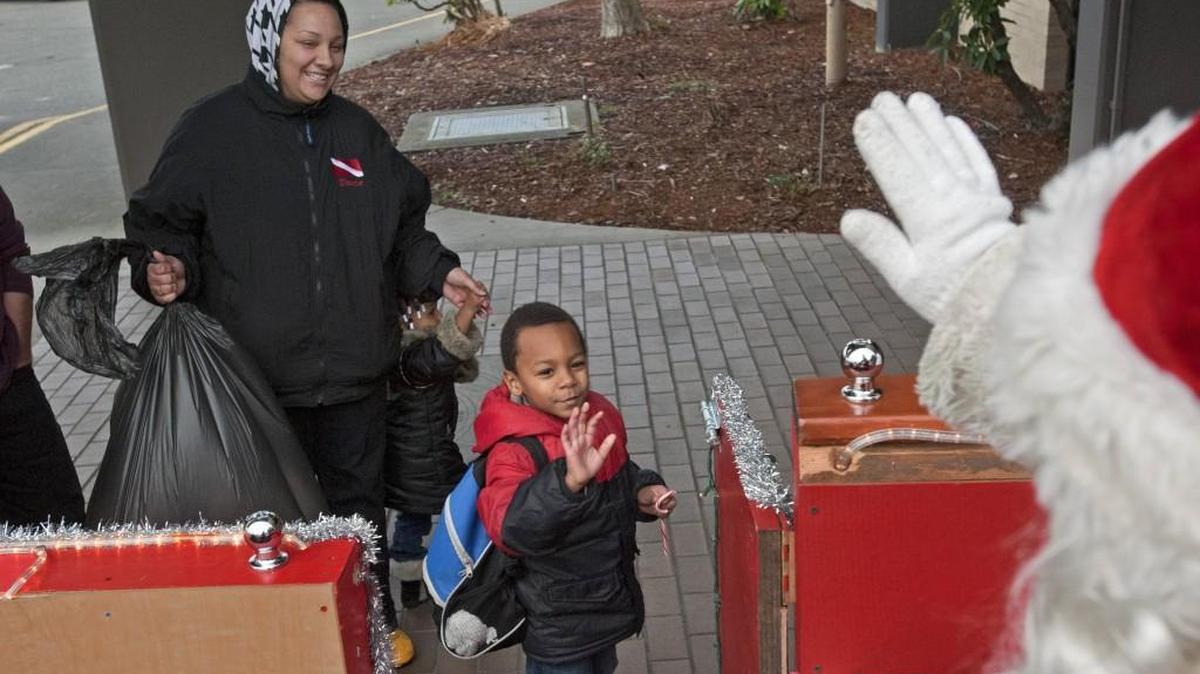 Dheaven Webber waves good-bye to Santa after he, sister Promise Caruthers and mom Monica Ayers received Christmas gifts in December 2011 from the Salvation Army’s Angel Toy ’n’ Joy store at the Tacoma Elks Lodge.