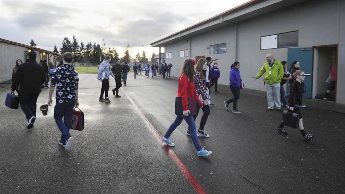 Yelm Middle School assistant principal Craig Curry chats with student as they bustle from the rows for portable classrooms between session periods Jan. 20th. The district was hoping to replace the existing middle school with a larger building to increase capacity and improve campus security as part of a bond measure. However, the latest ballot count shows the district’s bond request is failing for the second time in less than a year.