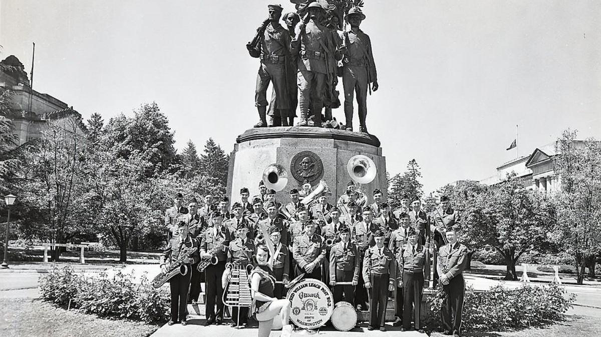 The Washington American Legion Band was formed in 1923 by the members of Alfred William Leach Post No. 3 of the American Legion. It is the oldest legion band in continuous existence in Washington State. It has received numerous awards and honors over the years and performs several times a year. Here the band poses in front of the Winged Victory statue on Capitol Campus, which honors men and women who served in World War I. This photograph was taken in 1942, during the second World War. Photograph selected and captioned by Deborah Ross on behalf of the Olympia Historical Society and Bigelow House Museum. For more information, visit us at olympiahistory.org. Credit: Merl Junk photo, 1942, Susan Parish Collection, Southwest Regional Archives More than 1,000 Washingtonians who lost their lives in World War I will be honored with a program at the Capitol Dome/Legislative Building’s Columbia Room (1st Floor) at 10:30 a.m., April 25, followed by a wreath laying at the Winged Victory Monument.