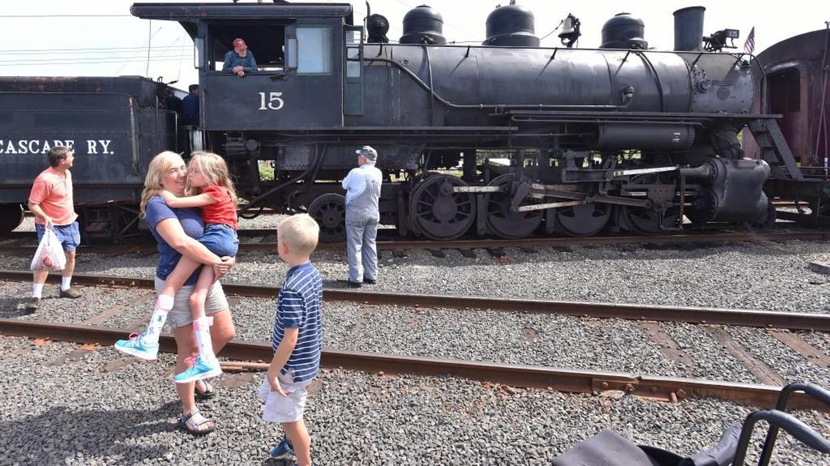 Kurt and Ellen Burgan along with their children Hannah,10 and Jeff, 7, say good buy and thank to to chief engineer Harold Bororvec after their exciting ride in the cabin of the 100 year-old number 15 locomotive on the Aug 13th afternoon run to Milburn with the Chehalis-Centralia Railroad and Museum's steam train ride.