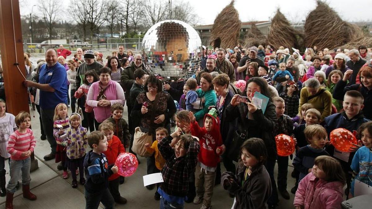 People cheer on Dec. 31, 2013, as the ball is dropped to celebrate the approaching new year at the Noon Years Eve kids’ party at the Hands On Children’s Museum.