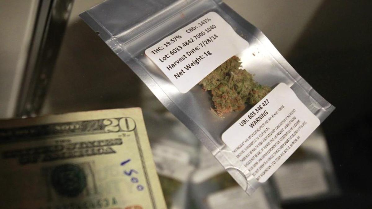 A gram of marijuana - tracked by a lot number and harvest date - sits on the counter at Green Lady Marijuana during the store's grand opening celebration on Friday, Aug. 29, 2014.