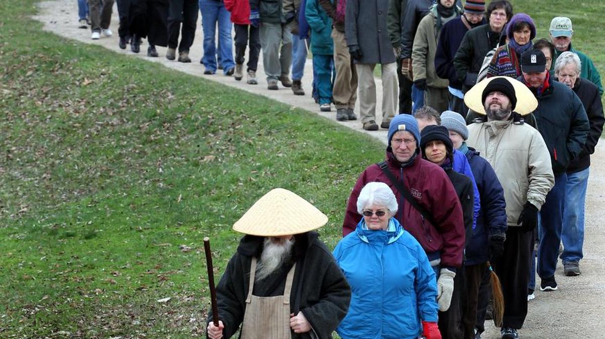 More than 100 walkers in single file took part in the 2013 South Sound Buddhist Peace Fellowship Meditative Walk for Peace around Capitol Lake held in honor of Dr. Martin Luther King Jr., the walk has is in its sixth year and features a silent and meditative walk around the lake for the participants.