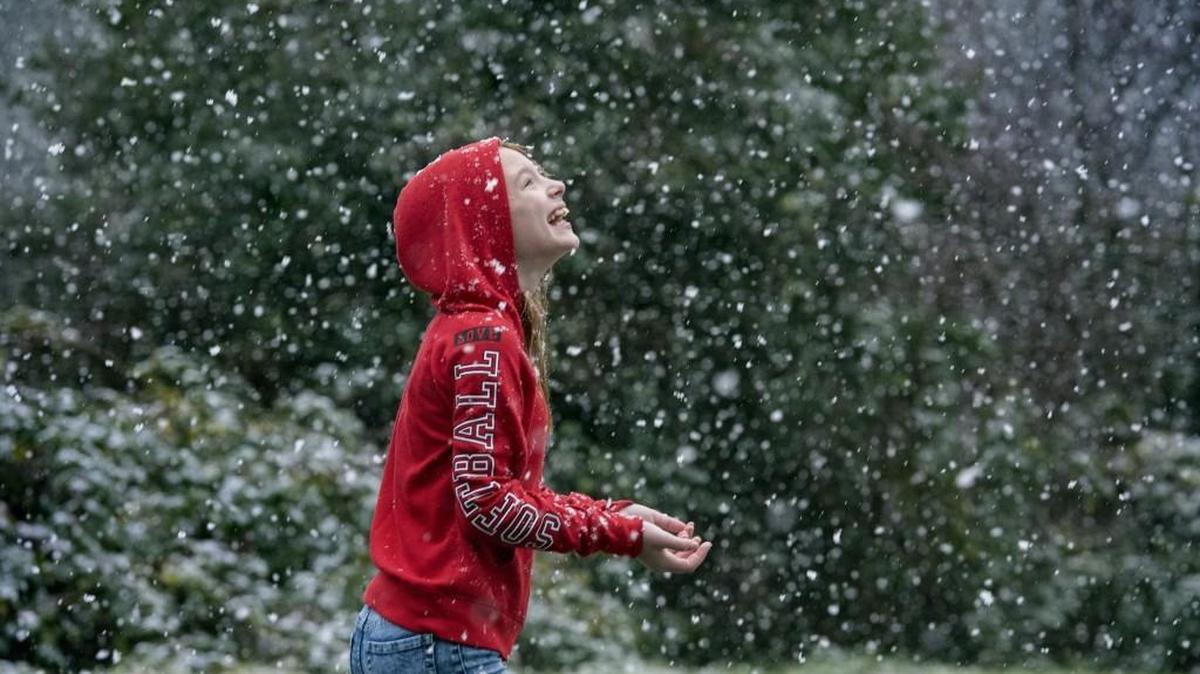 Alexis Ranslem, 12, walks through the falling snow in Tumwater on Monday, Dec. 21, 2015.