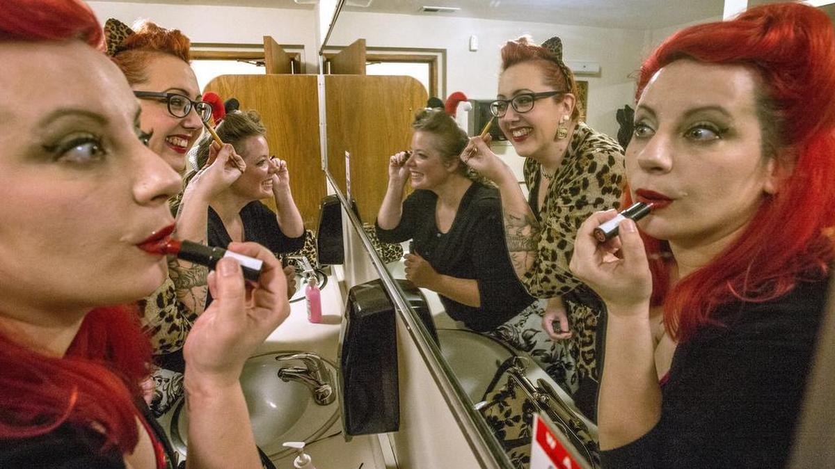 Members of the Olympia Rockabilly Mafia Dolls from left, Carrie Hockman, Leah Oliver and Stephanie Seitz, put the finishing touches on their 50's look Friday, October 23, 2015, before a benefit for Nickhole Arcade.